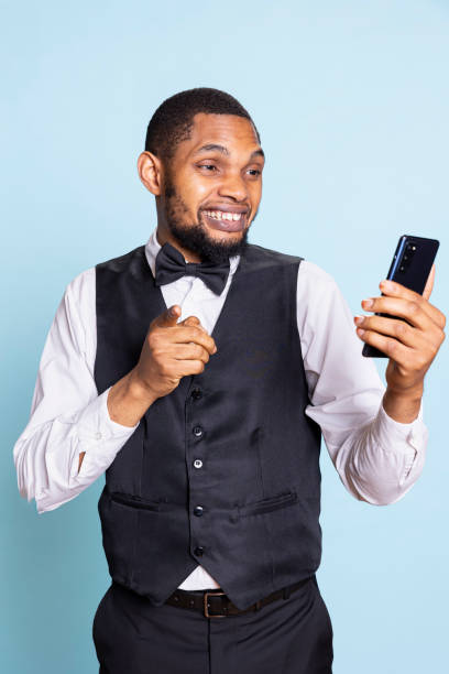 istock Smiling kind doorkeeper staff waving on online videocall in studio 2188617913