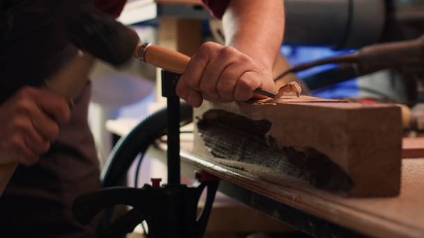 istock Woodworking professional in studio shaping wooden pieces, close up 2188632166
