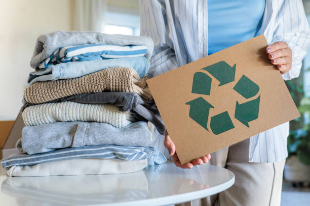 istock Female hands holding signboard textile clothes recycling reusing zero waste closeup 2188637390