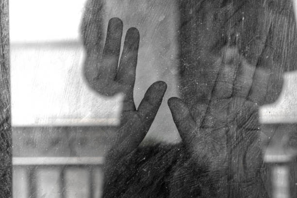 istock The mysterious boy's palm pressed against the dusty window glass. 2188651171