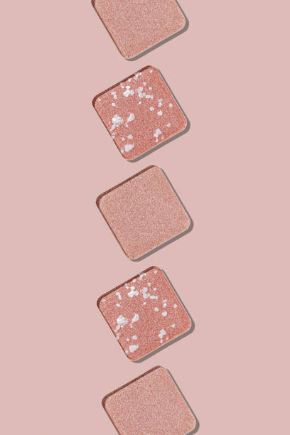 istock Swatches eyeshadow refills as minimal background. Monochrome Matte, glitter pans pale pink shade in row, detailed texture, sunlight, minimal trend cosmetics vertical photo, beauty product, eye makeup 2188652083