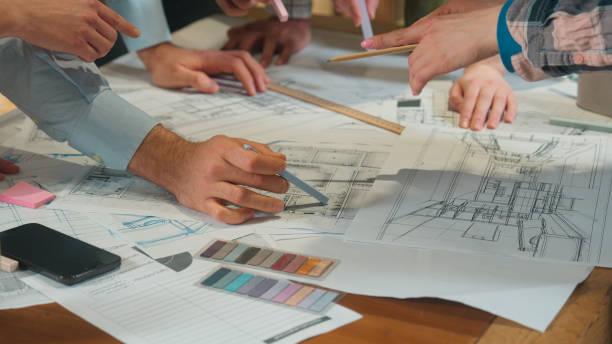 istock Office team multi ethnic designers male female group coworkers architects engineers constructors business men women discussing building plan construction blueprint chart architecture project on table 2188655941