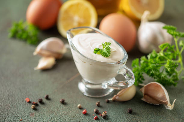 Garlic  Aioli sauce in bowl and ingredients  on the table.