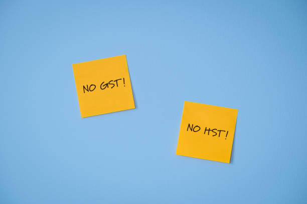 istock Canada GST HST Holiday Tax Break Sticky Notes on Blue Wall 2188658225