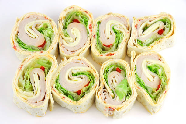 tortilla deli wrap rolls with ham vegetable isolated on white background