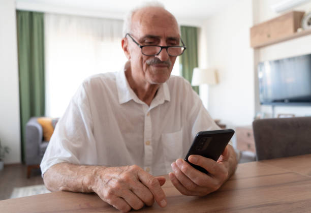 istock Senior man using smart phone at home 2188660316