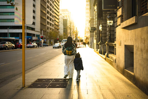 istock Mother And Son Walking Across Street 2188663536
