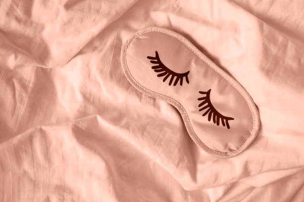 istock Sleep mask on white bedding. Healthy sleep concept. 2188669454