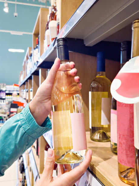 istock Bottle of white wine in hands 2188670393