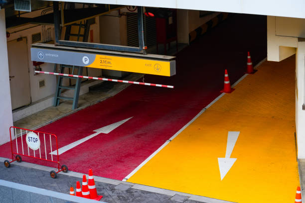 istock Barrier underground parking red entry and yellow exit arrows with a sign indicating a residential building 2188677221