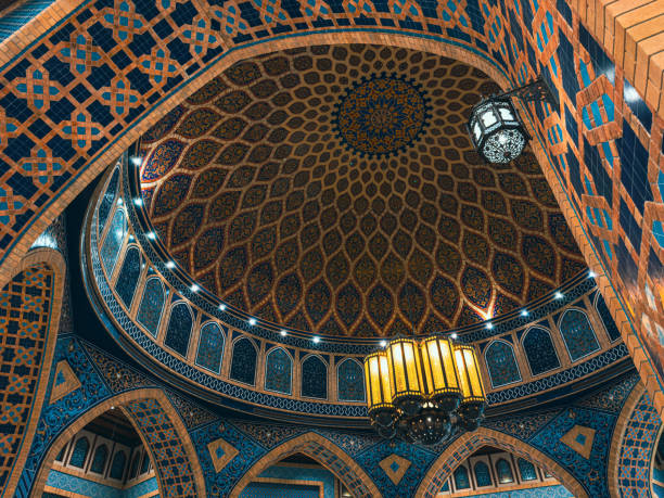 Al-Bukhari Foundation Mosque, Kuala Lumpur, Malaysia. Intricate white and gold dome interior with Arabic calligraphy and geometric patterns. Islamic architecture