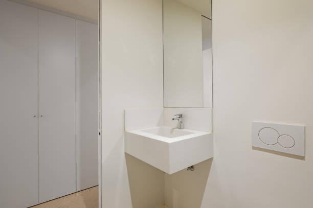 istock Modern simple bathroom with small sink, mirror and wardrobe in the background 2188680326