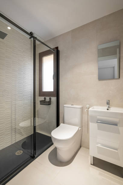 istock Modern empty bathroom with beige tiles, furniture and rectangular mirror 2188680655
