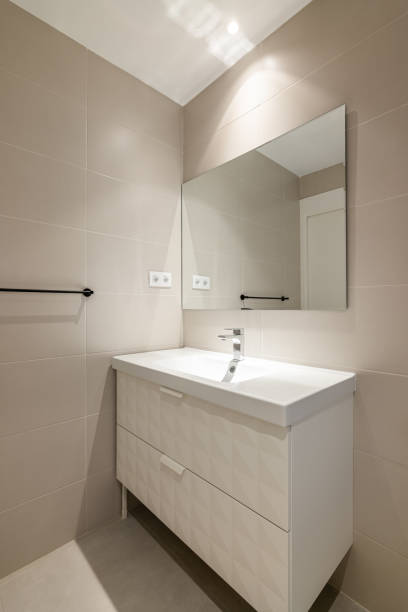 istock Simple, empty and modern bathroom with beige tiles, sink and mirror 2188680868