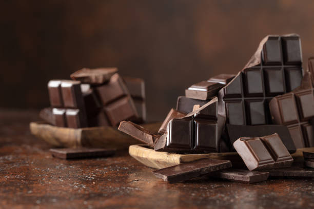 istock Broken bitter and milk chocolate bars on a brown background. 2188681244