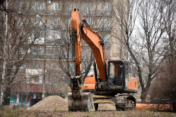 Excavator on earthworks. Excavator on construction site on sunset. Open-pit mining. Backhoe dig ground in quarry. Heavy construction equipment on excavation on construction site. Groundwork building