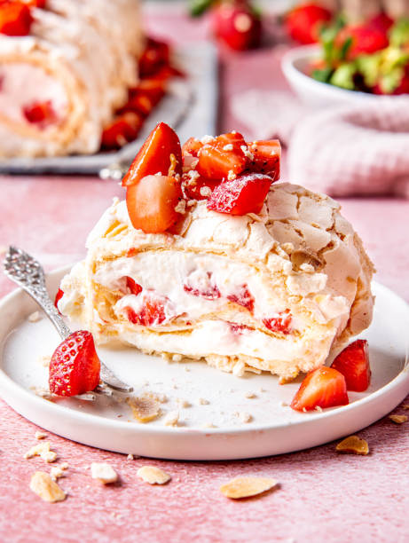 Sliced meringue roulade with fresh strawberries
