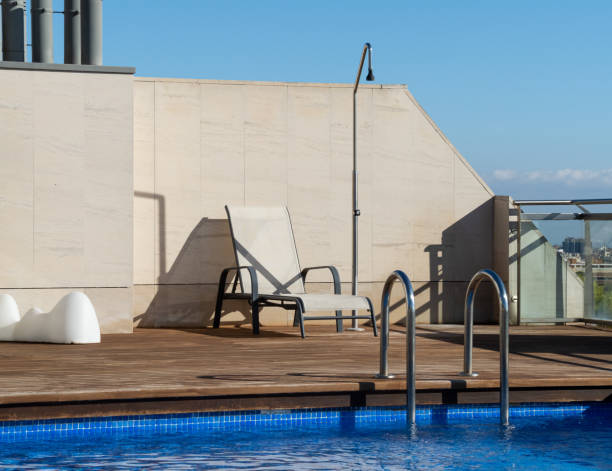 istock Swimming pool with sunbed on a roof top with clear blue sky 2188687747