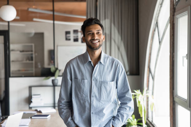 istock Confident young Indian male office employee posing at modern workplace 2188690913