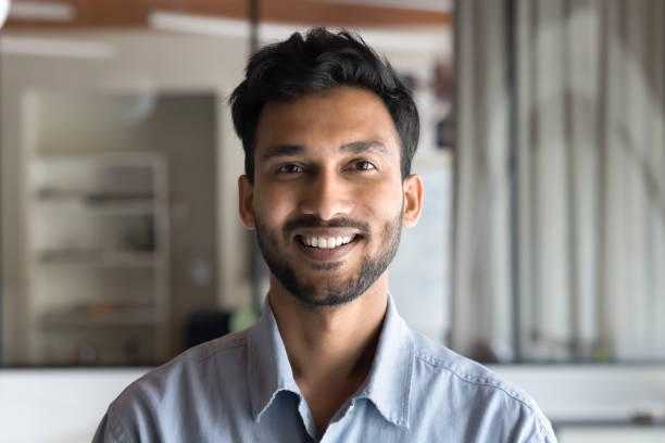 istock Head shot portrait happy Indian man posing indoor 2188691111