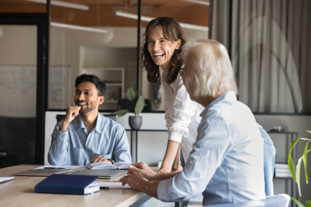 istock Diverse teammates laughing during group meeting in conference room 2188691265
