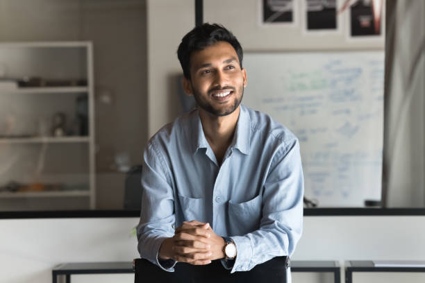 istock Young Indian businessman, gazing away with thoughtful expression 2188691705
