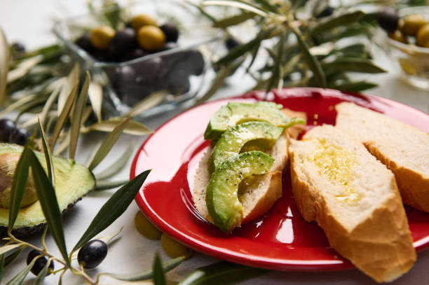 istock Fresh avocado slices and olive oil on bread with olives 2188692189
