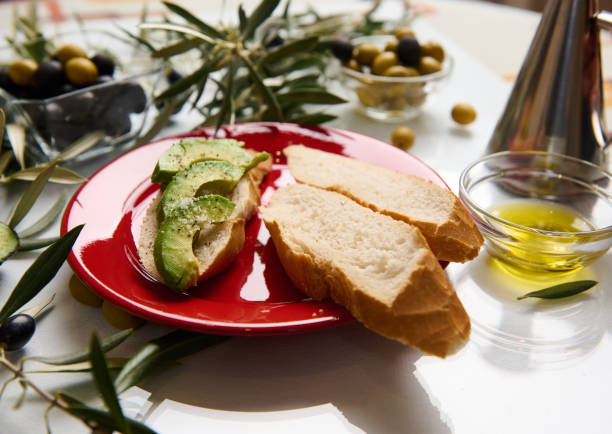 istock Delicious avocado toast with olives and olive oil on rustic table 2188692190
