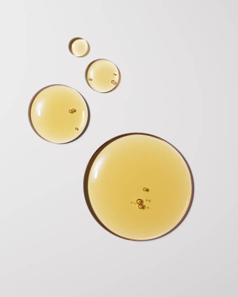 istock Argan oil liquid texture minimalist background 3d rendering, yellow serum drops on white, natural cosmetic concept. 2188692624