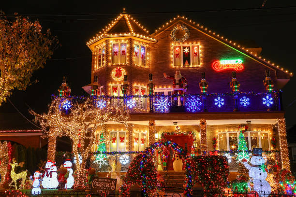 Boy tangled up in Christmas lights on front porch.