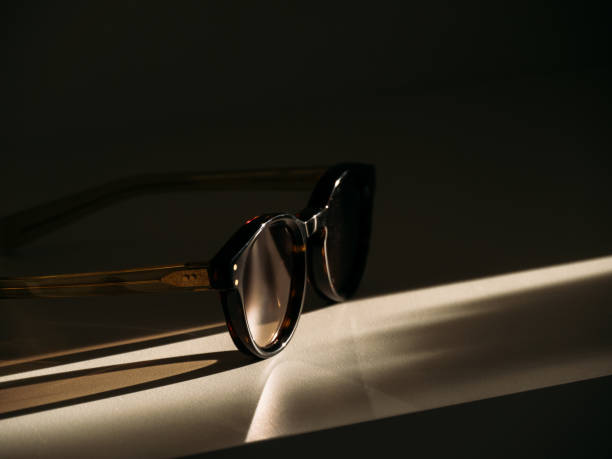 Trending form sunglasses on the table in beautiful morning sunlight.