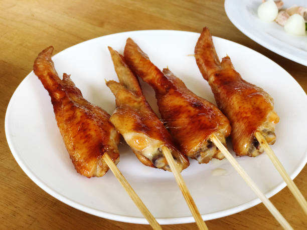 istock Fried chicken wings on white plate with dipping sauce on wooden table. 2188700380