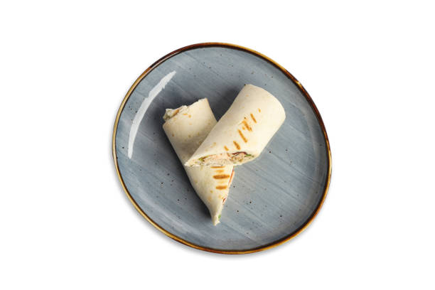 istock Sliced grilled tortilla roll with filling on a circular plate 2188703296