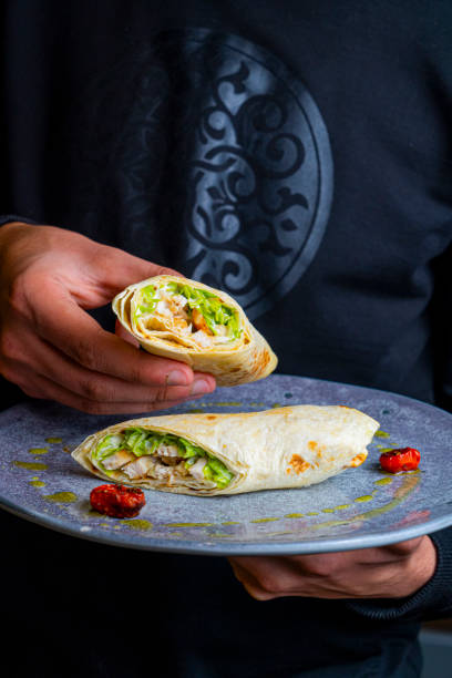 istock Delicious wrap on a blue plate with colorful toppings 2188705338