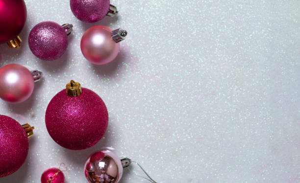 istock Assorted pink Christmas ornaments on glitter paper. 2188706713
