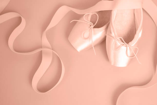istock Pink ballet pointe shoes with ribbons on pink background 2188706871