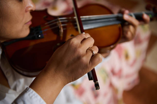 istock Close-up of a musician's hands playing a violin with focus on strings 2188706898