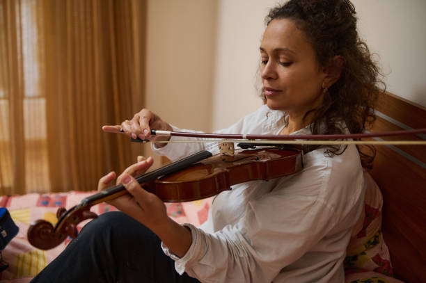 istock Woman playing violin indoors with focus and expression on her face 2188708506