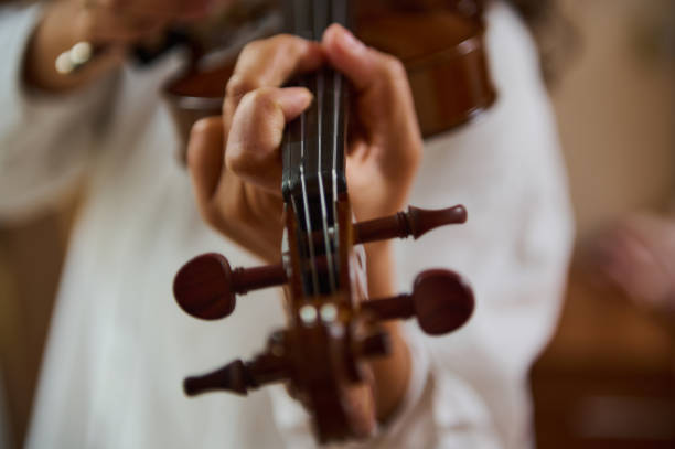 istock Close-up of a musician playing a violin with focus on the strings 2188708528