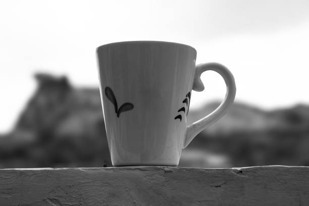 A ceramic mug filled with drink isolated on a blurred background