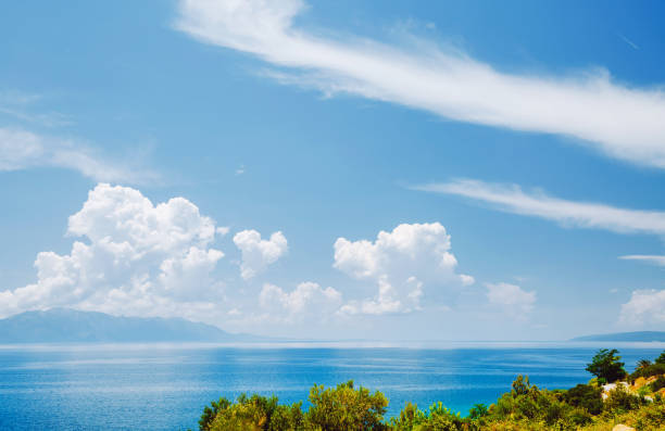 Peaceful view of the azure sea. Clear sky on a sunny day with white clouds. Scenic image of popular travel destination. Concept of seaside rest. Splendid morning scene. Discover the beauty of earth.