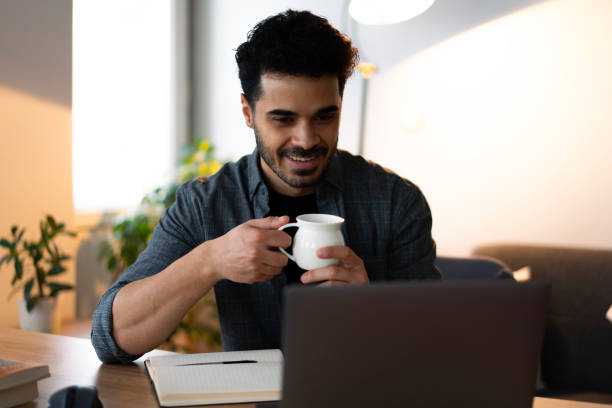 istock University student drinking coffee and studying at home 2188721504