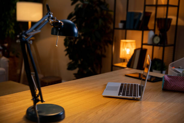 istock Creating a Cozy Home Office Setup Featuring a Desk Lamp and Laptop for Ultimate Comfort 2188723337