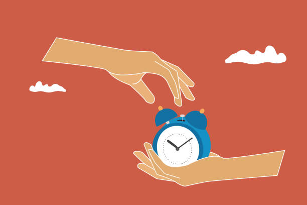 istock A hand holds an alarm clock. Concept of coming deadline 2188725891