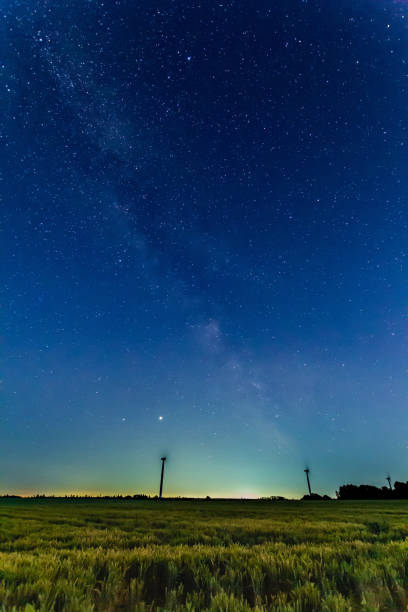 Night sky behind wind turbines