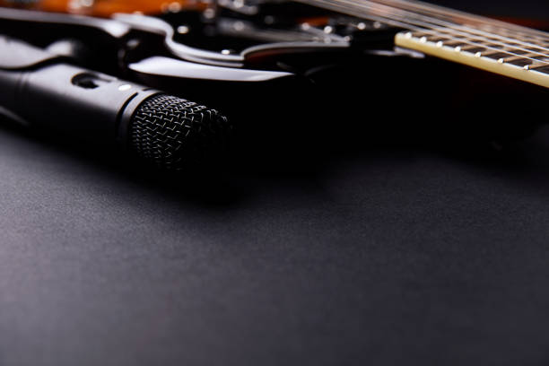 istock Microphone and electric guitar on a dark background. 2188727091