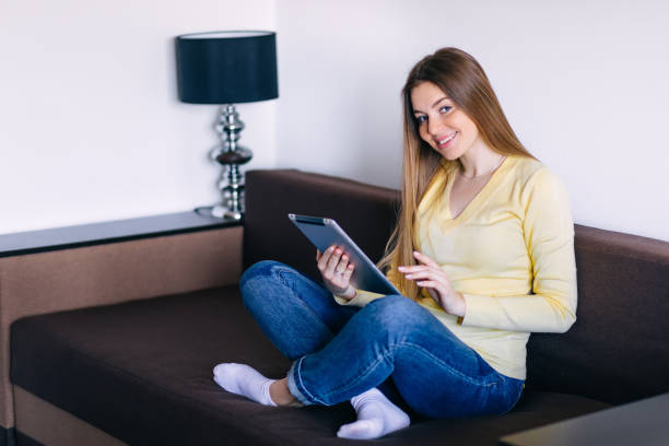 istock Chilling gorgeous freelancer on the beige couch at home doing on 2188727871