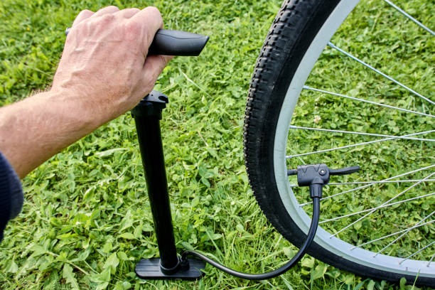 istock Using bicycle hand floor pump with dual nozzle adapter for schrader and presta valve. 2188728884
