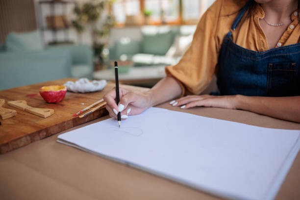 istock Female Artist Creating Pottery Sketches 2188738659