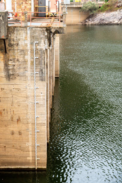 istock Concrete Dam Section with Water Level Gauge and Calm River 2188739006